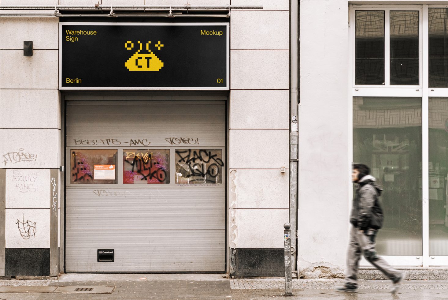 Urban storefront with digital sign mockup above graffiti-tagged shutter, pedestrian passing by, evoking contemporary street vibe for design.